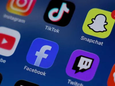 FILE PHOTO: Instagram, TikTok, Snapchat, YouTube, Facebook, Twitch and Reddit applications are displayed on a mobile phone in this picture illustration taken on December 9, 2025. REUTERS/Hollie Adams/Illustration/File Photo