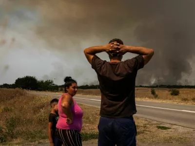 People watch as wildfire burns in Deliblatska Pescara, Serbia, August 7, 2026. REUTERS/Marko Djurica
