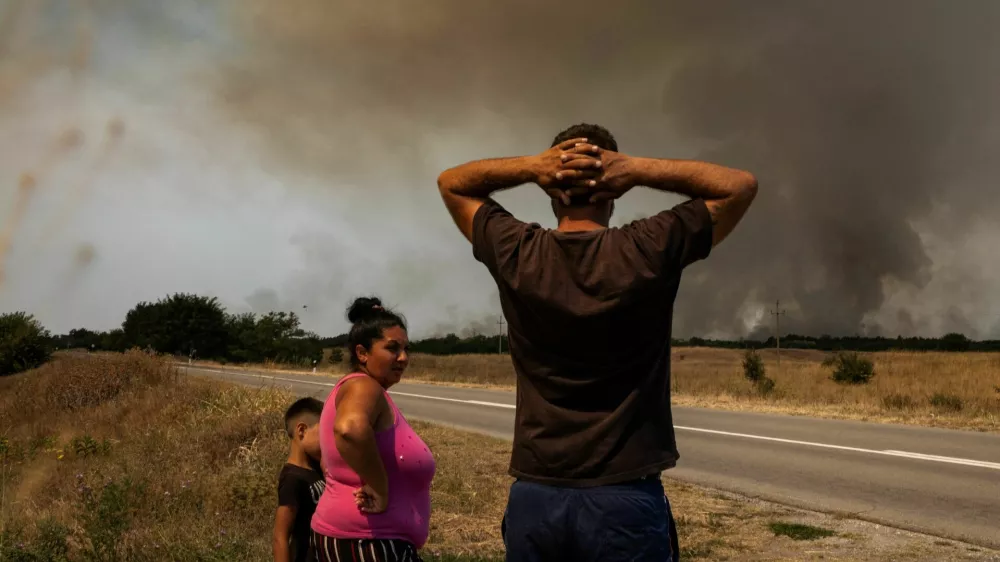 People watch as wildfire burns in Deliblatska Pescara, Serbia, August 7, 2026. REUTERS/Marko Djurica