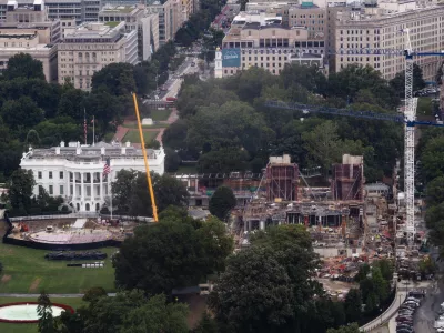 Construction continues on a helipad and the White House Ballroom on the South Lawn of the White House, Wednesday, Aug. 5, 2026, in Washington. (AP Photo/Tierney L. Cross)