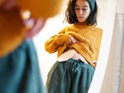reflection of a woman looking at the ostomy bag in the mirror at home. colon cancer / Foto: Sheila Alonso Getty Images