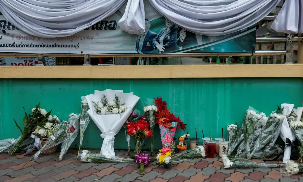 Flowers are left outside Debsirin Nonthaburi School in tribute to the victims, a day after a shooting incident at the school, in Bang Kruai district, Nonthaburi province, on the outskirts of Bangkok, Thailand, August 8, 2026. REUTERS/Chalinee Thirasupa