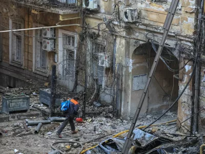 A resident leaves a site of apartment buildings damaged during a Russian missile and drone strike, amid Russia's attack on Ukraine, in Odesa, Ukraine, August 9, 2026. REUTERS/Nina Liashonok