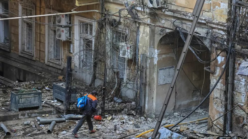 A resident leaves a site of apartment buildings damaged during a Russian missile and drone strike, amid Russia's attack on Ukraine, in Odesa, Ukraine, August 9, 2026. REUTERS/Nina Liashonok