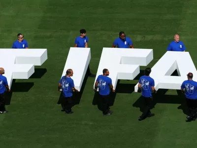FILE PHOTO: Soccer Football - FIFA World Cup 2026 - Final - Spain v Argentina - New York/New Jersey Stadium, East Rutherford, New Jersey, U.S. - July 19, 2026 Pitch staff carry the FIFA logo on the pitch before the match REUTERS/Mike Segar/File Photo