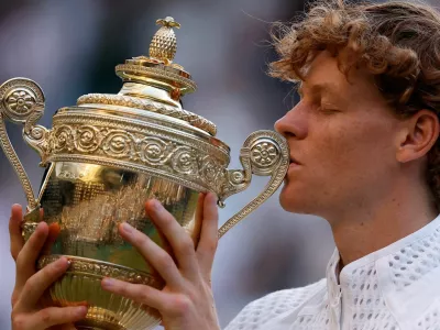 Tennis - Wimbledon - All England Lawn Tennis and Croquet Club, London, Britain - July 12, 2026 Italy's Jannik Sinner celebrates with the trophy after winning his final match against Germany's Alexander Zverev REUTERS/Andrew Couldridge   TPX IMAGES OF THE DAY