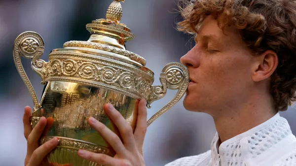 Tennis - Wimbledon - All England Lawn Tennis and Croquet Club, London, Britain - July 12, 2026 Italy's Jannik Sinner celebrates with the trophy after winning his final match against Germany's Alexander Zverev REUTERS/Andrew Couldridge   TPX IMAGES OF THE DAY
