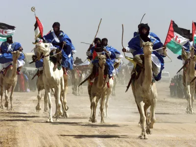 Sahrawi camel riders parade during celebrations for the 25th anniversary of the Polisario Front's independence movement for control of the Western Sahara from Morocco February 27, 2001 in the El Ayoun refugee camp in southwestern Algeria. Fifteen years of guerrilla war from 1976 to 1991, followed by a decade of international efforts to organize a referendum, have yet to settle the dispute over who the territory belongs to. REUTERS/Paul Hanna