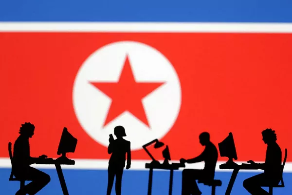 FILE PHOTO: Miniatures of people with computers are seen in front of North Korea flag in this illustration taken July 19, 2023. REUTERS/Dado Ruvic/Illustration/File Photo