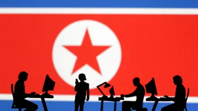 FILE PHOTO: Miniatures of people with computers are seen in front of North Korea flag in this illustration taken July 19, 2023. REUTERS/Dado Ruvic/Illustration/File Photo