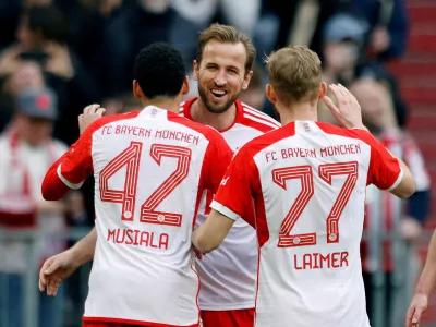 Soccer Football - Bundesliga - Bayern Munich v 1. FSV Mainz 05 - Allianz Arena, Munich, Germany - March 9, 2024 Bayern Munich's Harry Kane celebrates scoring their seventh goal to complete his hat-trick with Jamal Musiala and Konrad Laimer REUTERS/Michaela Stache DFL REGULATIONS PROHIBIT ANY USE OF PHOTOGRAPHS AS IMAGE SEQUENCES AND/OR QUASI-VIDEO. TPX IMAGES OF THE DAY