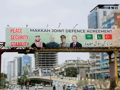 A billboard displays portraits of Saudi Crown Prince and Prime Minister Mohammed bin Salman, Pakistan's Prime Minister Muhammad Shehbaz Sharif, Pakistan's Chief of Defence Forces (CDF) and Chief of Army Staff, Field Marshal Asim Munir, and Turkish President Recep Tayyip Erdogan, following the signing of the Makkah Joint Defence Agreement, in Karachi, Pakistan, August 9, 2026. REUTERS/Akhtar Soomro