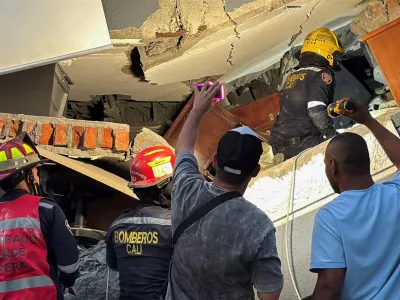 Emergency personnel dig through debris at the site of a collapsed building as recovery efforts continue at night following an earthquake, in Cali, Colombia August 10, 2026. Picture taken with a mobile phone. REUTERS/Marco Trujillo