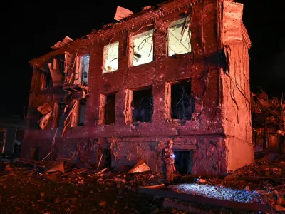 A resident stands next to a building damaged by an overnight Russian missile strike, amid Russia's attack on Ukraine, in Zaporizhzhia, Ukraine August 11, 2026. REUTERS/Stringer
