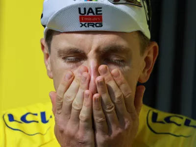 Cycling - Tour de France - Stage 15 - Champagnole to Plateau de Solaison - Plateau de Solaison, France - July 19, 2026 UAE Team Emirates XRG's Tadej Pogacar reacts on the podium wearing the yellow jersey after stage 15 REUTERS/Stephanie Lecocq