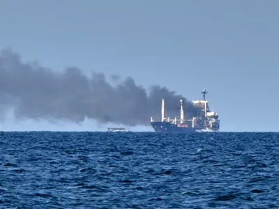Smoke rises from the grain carrier Golden Leo&nbsp;under the Guinea-Bissau flag after Russian missile strike in the Black Sea close to Odesa, Ukraine, Sunday, July 19, 2026, local media reports. (AP Photo/Michael Shtekel)
