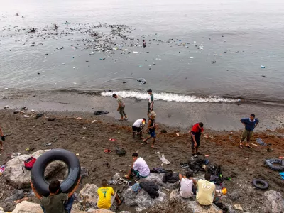 Belongings left behind by migrants float in the sea after they crossed from Morocco into the Spanish enclave of Ceuta, Friday, July 31, 2026. (AP Photo/Antonio Sempere)