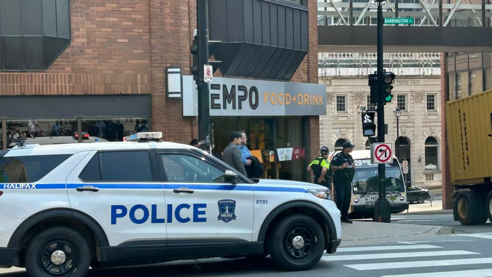 Police direct people asked to evacuate at the intersection of Barrington Street and Duke Street, in downtown Halifax, on Monday, Aug. 10, 2026. (Devin Stevens /The Canadian Press via AP)