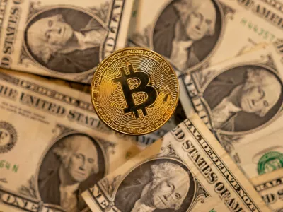 FILE PHOTO: A representation of virtual cryptocurrency Bitcoin is placed on U.S. Dollar banknotes in this illustration taken November 28, 2021. REUTERS/Dado Ruvic/Illustration/File Photo