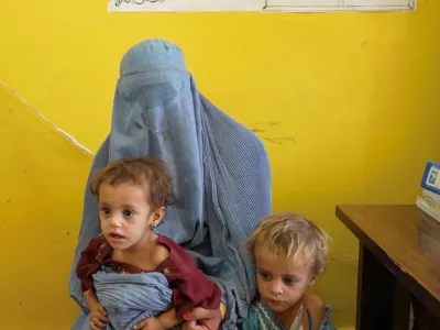 Sadiqa, 30, from Helmand, speaks while with two of her daughters, Sofia and Nazdana, who are suffering from malnutrition, at a clinic in Helmand, Afghanistan, July 14, 2026, in this still image taken from a handout video. WFP/Handout via REUTERS THIS IMAGE HAS BEEN SUPPLIED BY A THIRD PARTY. MANDATORY CREDIT.