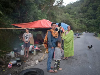 People take shelter in makeshift tent amid fears of aftershocks, following an earthquake in Reo, East Nusa Tenggara province, Indonesia, Monday, Aug. 17, 2026. (AP Photo/Firdia Lisnawati)