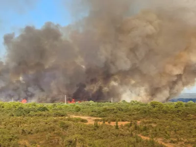 Smoke from a wildfire rises in Zadar, Croatia, August 14, 2026, in this screen grab obtained from a social media video. DOMINIK BRKLJACA/via REUTERS THIS IMAGE HAS BEEN SUPPLIED BY A THIRD PARTY. MANDATORY CREDIT. NO RESALES. NO ARCHIVES. Verification: -Buildings, terrain and roads that matched the archive and satellite imagery of the area -Coordinates: 44.162936, 15.227675 -Original file metadata -Croatian Fire Service reports of the fire