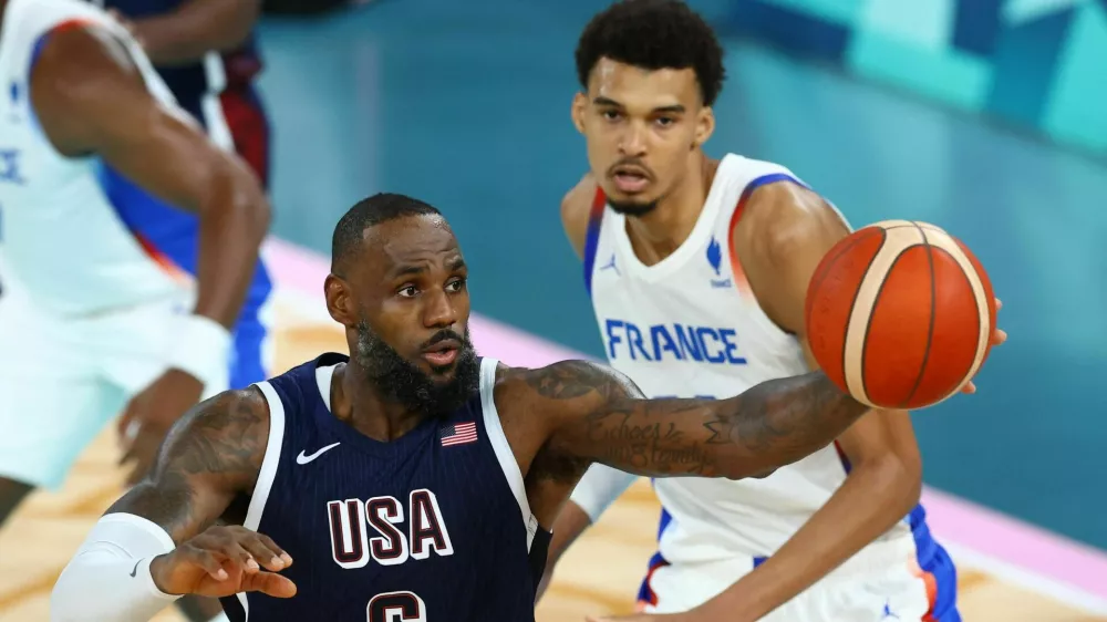 Paris 2024 Olympics - Basketball - Men's Gold Medal Game - France vs United States - Bercy Arena, Paris, France - August 10, 2024. Lebron James of United States in action with Victor Wembanyama of France. REUTERS/Stephanie Lecocq