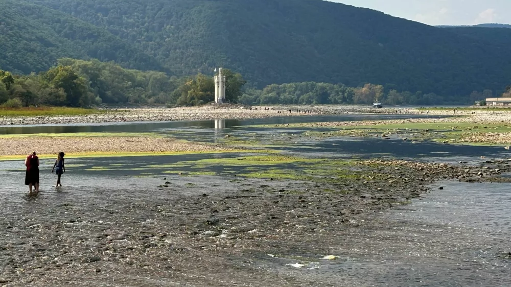 Due to low water level people walk over stones, which are usually covered by the Rhine river near the "Binger Maeuseturm" (Bingen Mouse Tower), Bingen, Germany, August 16, 2026, during prolonged dry weather across Europe that causes massive consequences for German industry.  REUTERS/Ilona Wissenbach   TPX IMAGES OF THE DAY / Foto: Ilona Wissenbach
