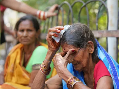 A woman cools herself off with an ice pack during a heat wave in Banda, northern Indian state of Uttar Pradesh, Sunday, June 21, 2026. (AP Photo/Rajesh Kumar Singh)