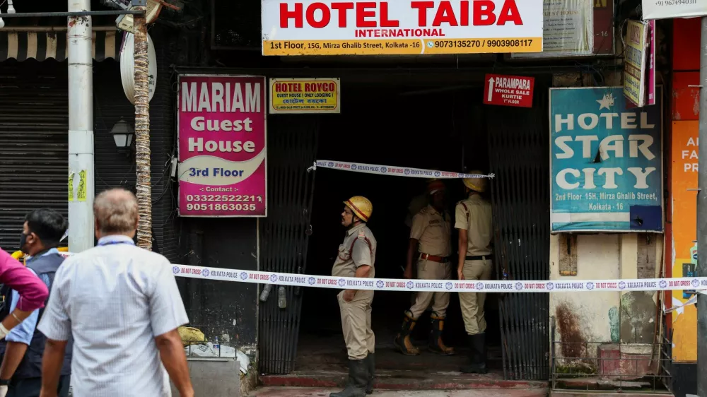 Firefighters stand at an entryway to a hotel where a fire broke out and killed several people, in Kolkata, India, August 19, 2026. REUTERS/Sahiba Chawdhary