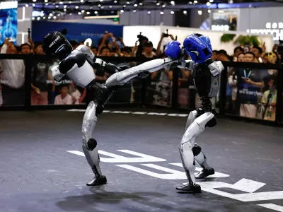 Humanoid robots by Unitree Robotics demonstrate kickboxing during the 2026 World Robot Conference, in Beijing, China August 19, 2026. REUTERS/Tingshu Wang