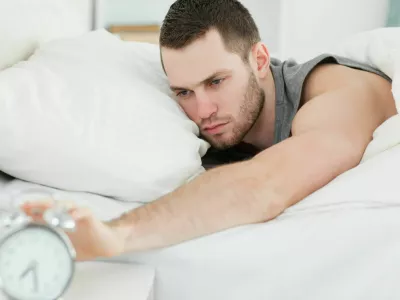 Man waking up in his bedroom