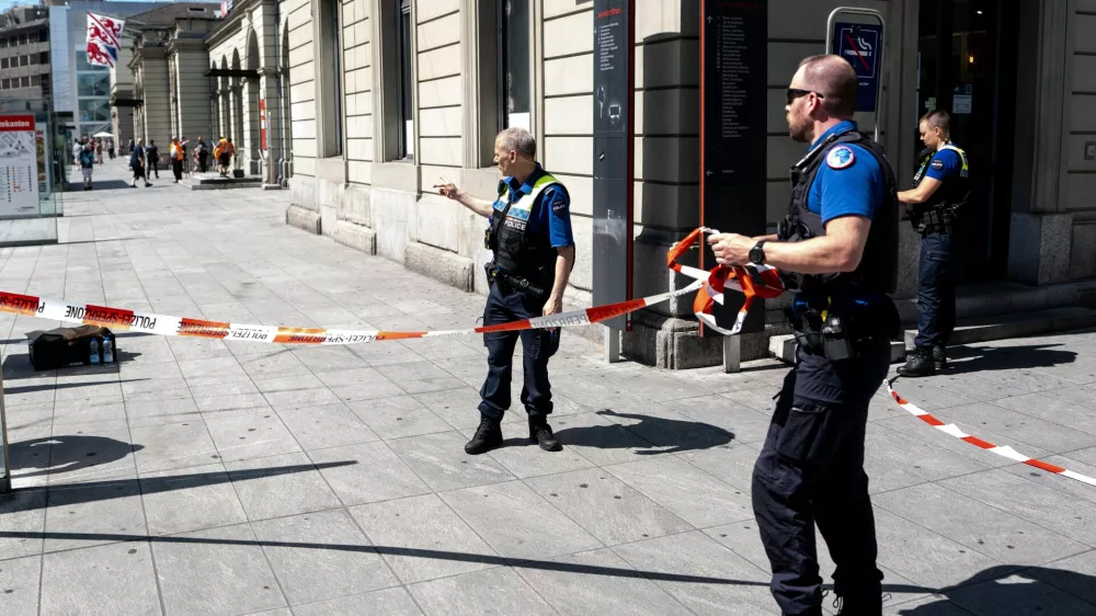 Police officers remove tape following a stabbing attack at the train station in Winterthur, Switzerland, Thursday, May 28, 2026. (Claudio Thoma/Keystone via AP)