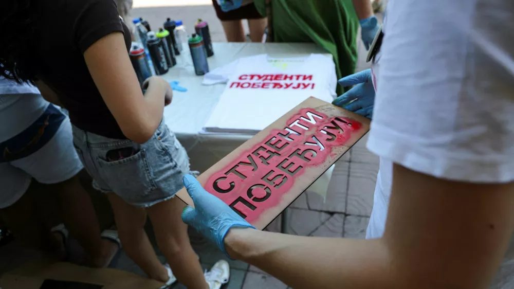A volunteer carries a stencil with the slogan "Students are winning" to spray onto T-shirts as students gather during a protest as part of a nationwide anti-government movement triggered by the deadly collapse of the Novi Sad railway station canopy in November 2024, following Serbian President Aleksandar Vucic's resignation announcement, in Kraljevo, Serbia, June 28, 2026. REUTERS/Djordje Kojadinovic