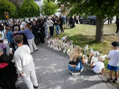 Fagersta residents leave flowers and candles at a makeshift memorial outside a shool in Fagersta, Sweden, on Aug. 22, 2026, the day after a 17-year-old girl was killed and three others injured at the school by a man with a sword.,Image: 1127307155, License: Rights-managed, Restrictions:, Model Release: no 