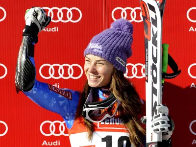 Slovenia's Tina Maze celebrates on the podium after winning an alpine ski, women's World Cup super-G, in St. Anton, Austria, Sunday, Jan. 13, 2013. (AP Photo/Giovanni Auletta)