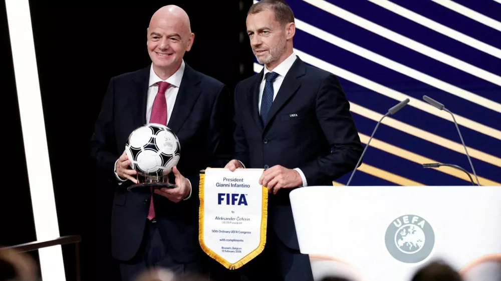 FILE PHOTO: Soccer Football - 50th Ordinary UEFA Congress - Brussels Expo, Brussels, Belgium - February 12, 2026 UEFA president Aleksander Ceferin and FIFA president Gianni Infantino pose for a photograph during the event REUTERS/Benoit Tessier/File Photo