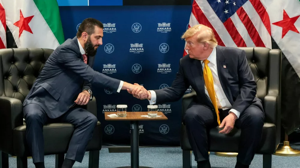 FILE PHOTO: U.S. President Donald Trump shakes hands with Syrian President Ahmed al-Sharaa during a bilateral meeting alongside the NATO leaders summit at the Bestepe Presidential Compound in Ankara, Turkey, July 8, 2026. REUTERS/Jonathan Ernst/File Photo