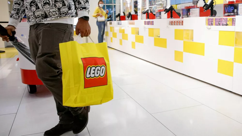 FILE PHOTO: A customer carries a bag while shopping in the 5th Avenue Lego store in New York City, U.S., September 28, 2021. REUTERS/Brendan McDermid/File Photo