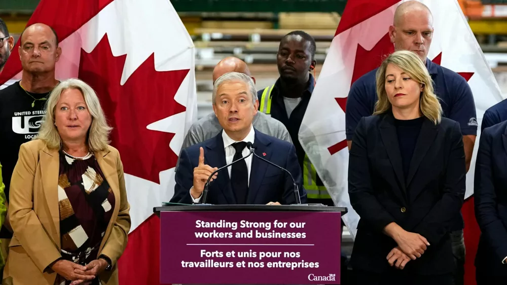 Minister of Finance and National Revenue Francois-Philippe Champagne speaks at a news conference on Canada's response to U.S. tariffs, at a roofing company in Ottawa, on Tuesday, Aug. 25, 2026. (Justin Tang/The Canadian Press via AP)