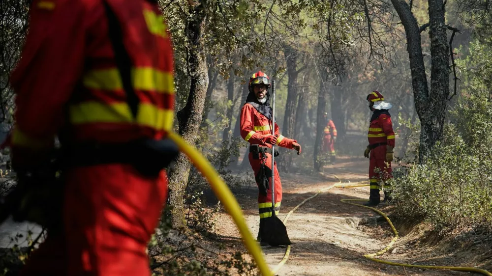 Members of the Military Emergencies Unit (UME) refresh the area after putting out a fire in San Martin de Valdeiglesias, Madrid, Spain July 26, 2026. REUTERS/Ana Beltran