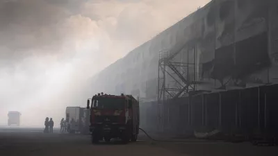 Smoke rises above warehouse stores after a Russian air attack in Kyiv, Ukraine, Thursday, Aug. 27, 2026. (AP Photo/Efrem Lukatsky)