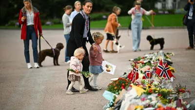People gather and lay flowers outside the Royal Palace, as Norway's King Harald is hospitalized at the National Hospital, in Oslo, Norway, August 28, 2026. REUTERS/Dylan Martinez