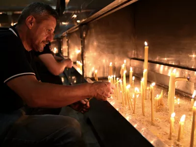 People light candles for former Bosnian Serb wartime general Ratko Mladic, in front of church in the Bosnian town of Banja Luka, 240 kms. (140 miles) northwest of Sarajevo, Thursday, August. 27, 2026. (AP Photo/Radivoje Pavicic)