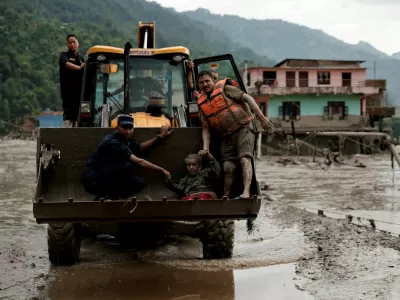 FILE PHOTO: A survivor is transported to a safer place in heavy machinery following a flash flood at Trishuli in Nuwakot district, Nepal, August 26, 2026. REUTERS/Navesh Chitrakar/File Photo