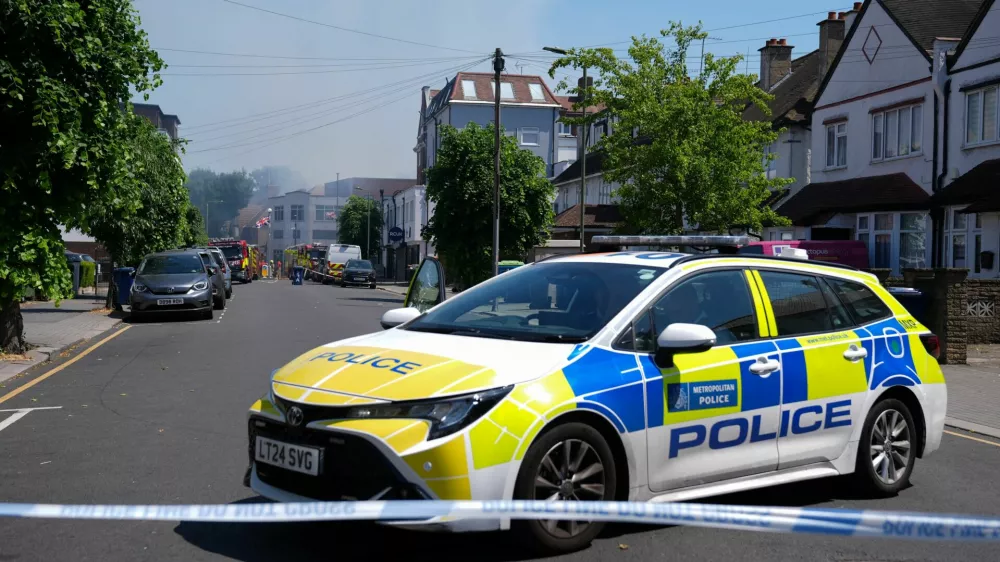 Police officers sit in a police cruiser near the scene of a fire started behind a Jewish supermarket Kosher Kingdom, in the Golders Green area of London, Britain, May 27, 2026. REUTERS/Maja Smiejkowska