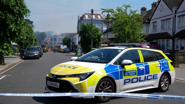Police officers sit in a police cruiser near the scene of a fire started behind a Jewish supermarket Kosher Kingdom, in the Golders Green area of London, Britain, May 27, 2026. REUTERS/Maja Smiejkowska