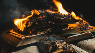 Open book is on fire, pages are engulfed in flames. Concept of censorship, prohibition of freedom information, 451 fahrenheit, old literature in paper format is no longer in demand. High photo