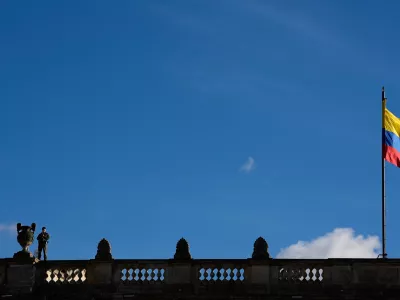 A soldier stands guard on a rooftop of Colombia's Congress before a vigil in honor of earthquake victims in Bogota, Colombia, Friday, Aug. 28, 2026. (AP Photo/Fernando Vergara)
