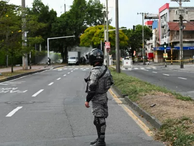 A soldier stands guard following the explosion of a cargo vehicle near an Aerospace Force base, in one of two attacks attributed to FARC dissident groups, that caused multiple casualties, according to authorities, in Cali, Colombia August 21, 2025. REUTERS/Oswaldo Paez